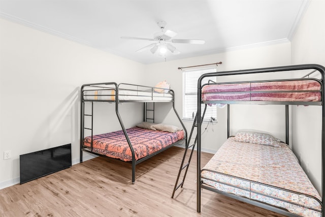 bedroom with ceiling fan, light hardwood / wood-style flooring, and crown molding