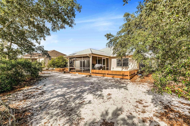 view of front of house featuring a sunroom and a wooden deck