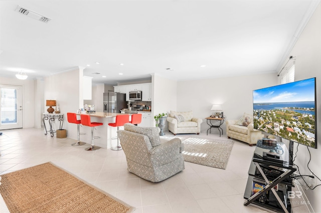 living room featuring ornamental molding and light tile patterned floors