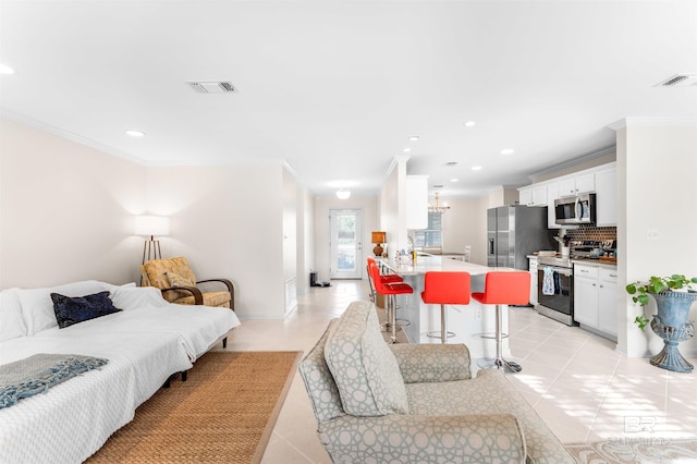 bedroom featuring sink, crown molding, light tile patterned floors, and stainless steel refrigerator with ice dispenser