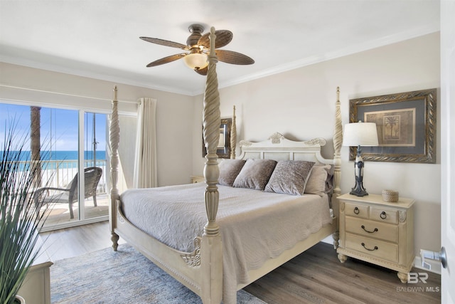 bedroom with ceiling fan, ornamental molding, wood finished floors, a water view, and access to outside