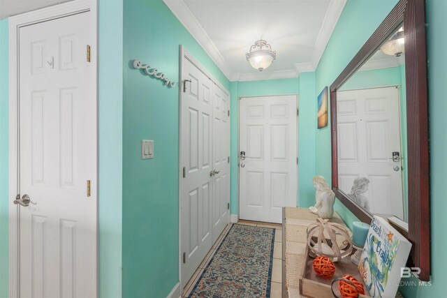 615 W Beach Blvd Unit 1E, Gulf Shores, AL 36542 - doorway with ornamental molding and tile patterned floors