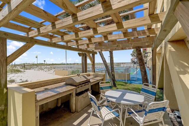615 W Beach Blvd Unit 1E, Gulf Shores, AL 36542 - view of patio / terrace with a water view, outdoor dining area, a pergola, area for grilling, and fence