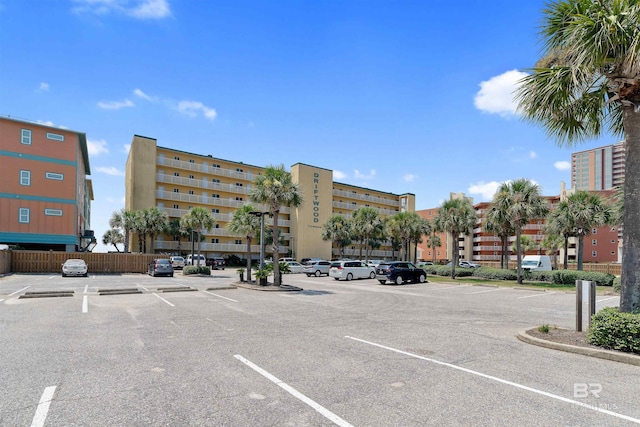 615 W Beach Blvd Unit 1E, Gulf Shores, AL 36542 - view of building exterior with uncovered parking and fence