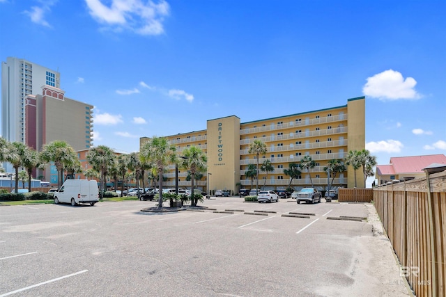 615 W Beach Blvd Unit 1E, Gulf Shores, AL 36542 - view of building exterior with uncovered parking and fence