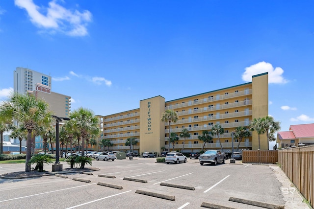 615 W Beach Blvd Unit 1E, Gulf Shores, AL 36542 - view of apartment building / complex with uncovered parking and fence
