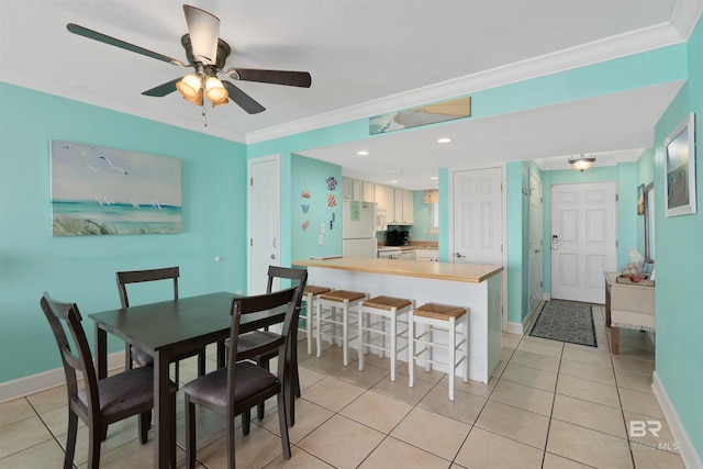 615 W Beach Blvd Unit 1E, Gulf Shores, AL 36542 - dining area with crown molding, light tile patterned floors, a ceiling fan, and baseboards