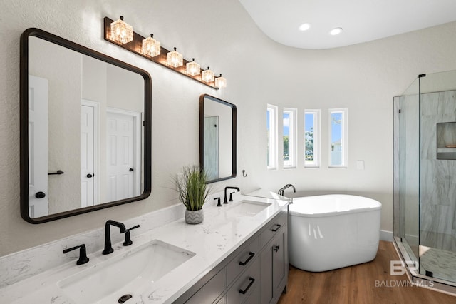 bathroom featuring separate shower and tub, vanity, and wood-type flooring