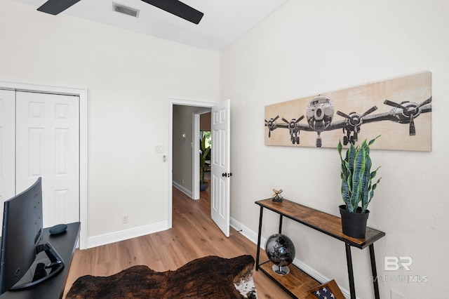 office space with light hardwood / wood-style floors and ceiling fan