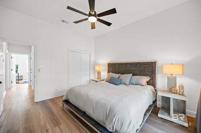 bedroom featuring hardwood / wood-style floors, ceiling fan, and a closet