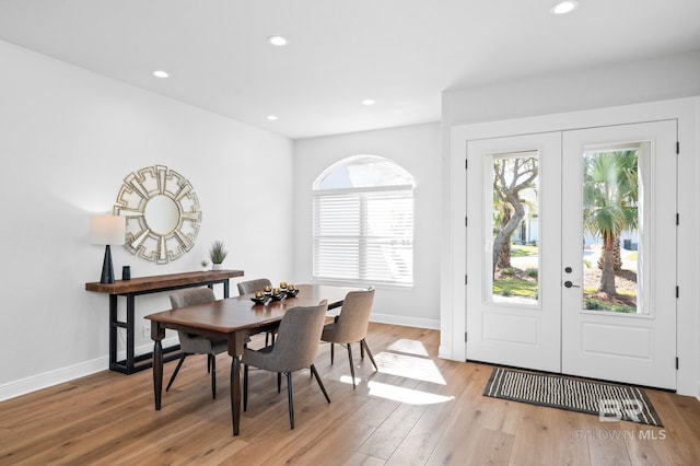 dining area with light hardwood / wood-style flooring and french doors