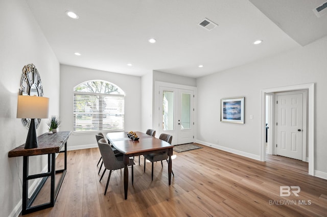 dining area featuring french doors and light hardwood / wood-style flooring