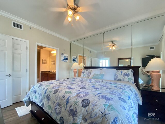 1010 W Beach Blvd Unit 209, Gulf Shores, AL 36542 - bedroom with dark wood finished floors, ornamental molding, ensuite bathroom, and a ceiling fan
