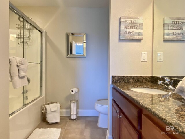 1010 W Beach Blvd Unit 209, Gulf Shores, AL 36542 - full bath with tile patterned floors, toilet, vanity, and combined bath / shower with glass door