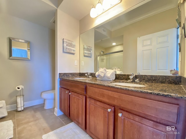 1010 W Beach Blvd Unit 209, Gulf Shores, AL 36542 - bathroom with a shower stall, tile patterned flooring, double vanity, baseboards, and toilet