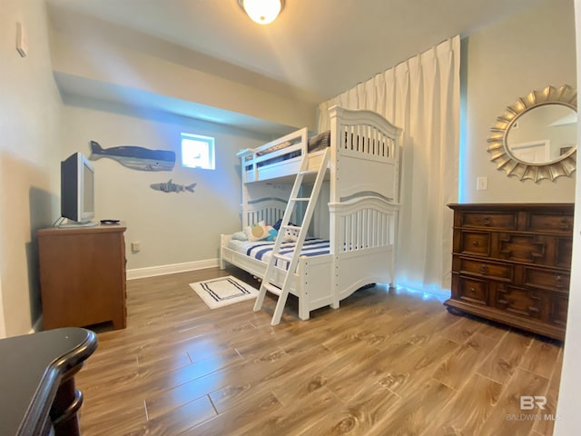 1010 W Beach Blvd Unit 209, Gulf Shores, AL 36542 - bedroom with wood finished floors and baseboards