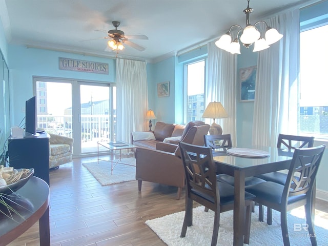 1010 W Beach Blvd Unit 209, Gulf Shores, AL 36542 - dining room with a chandelier, healthy amount of natural light, wood finished floors, ceiling fan, and crown molding