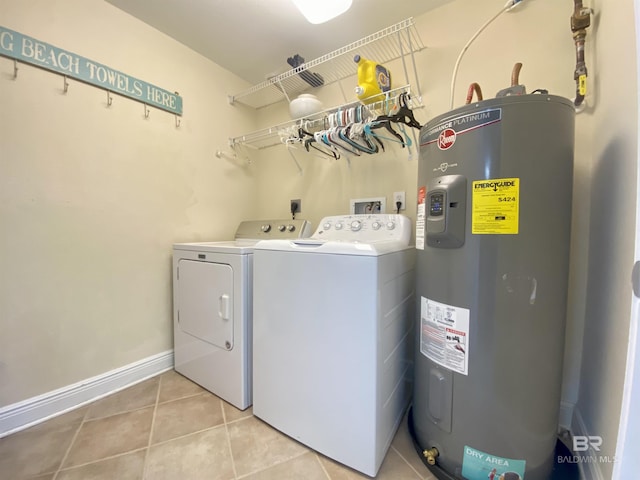 1010 W Beach Blvd Unit 209, Gulf Shores, AL 36542 - laundry area featuring water heater, washer and clothes dryer, light tile patterned floors, and baseboards