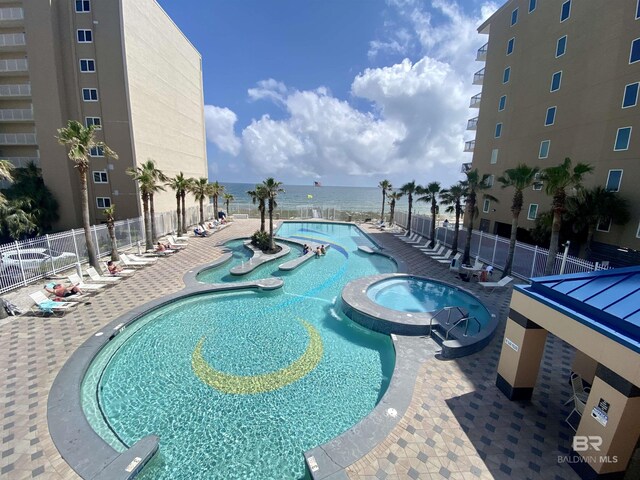 1010 W Beach Blvd Unit 209, Gulf Shores, AL 36542 - view of swimming pool with a water view and a pool with connected hot tub