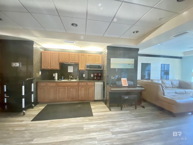 1010 W Beach Blvd Unit 209, Gulf Shores, AL 36542 - kitchen featuring stainless steel microwave, a drop ceiling, a sink, light wood finished floors, and decorative backsplash