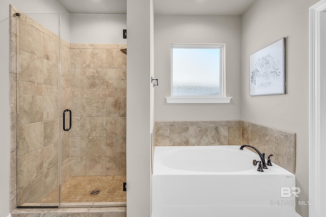 full bath featuring a stall shower and a garden tub
