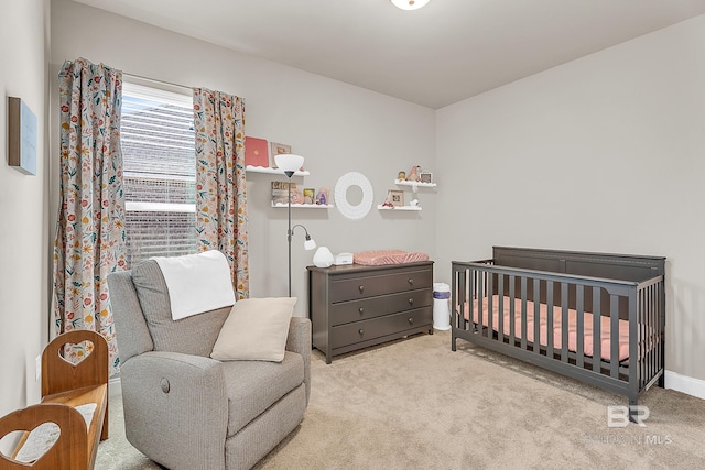bedroom featuring a crib and carpet
