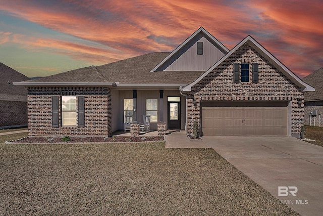 view of front of property with concrete driveway, brick siding, a lawn, and an attached garage