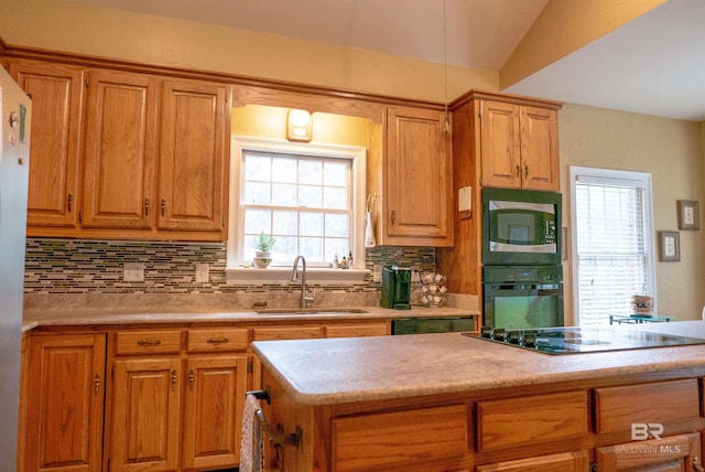 kitchen with tasteful backsplash, sink, and black appliances