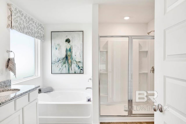 bathroom featuring independent shower and bath, vanity, and hardwood / wood-style floors