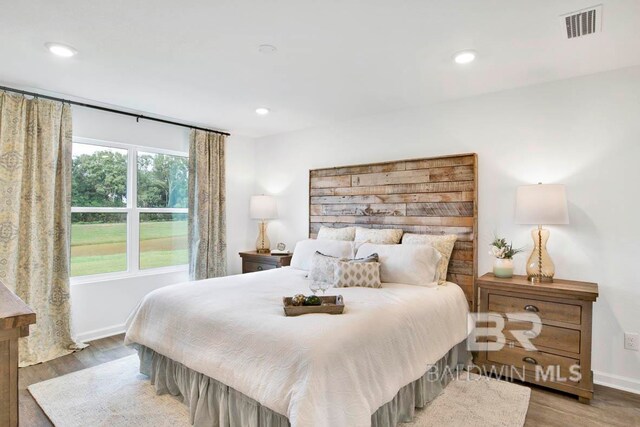 bedroom with hardwood / wood-style floors