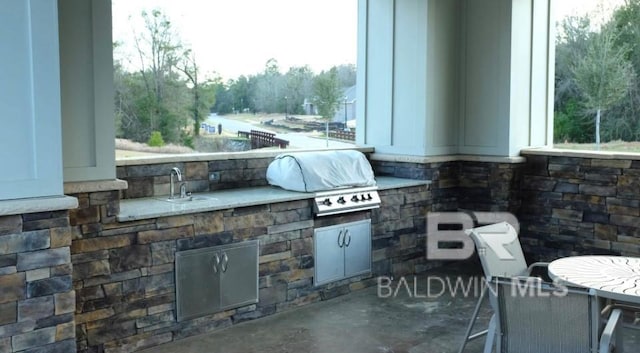 view of patio with area for grilling, sink, and grilling area