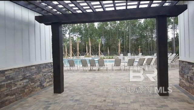 view of patio with a pergola and a community pool