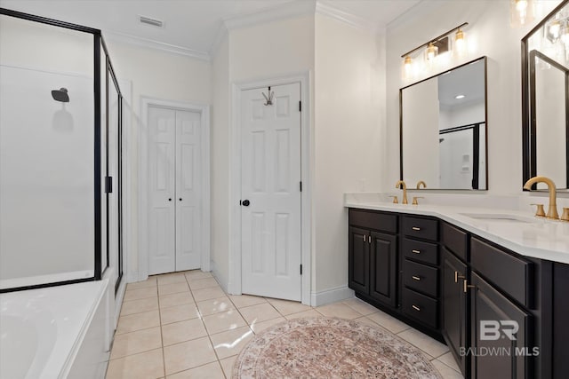 bathroom featuring tile patterned floors, vanity, a shower with door, and crown molding