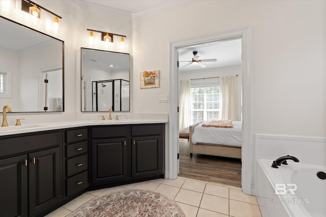 bathroom with vanity, a shower with door, crown molding, tile patterned flooring, and ceiling fan