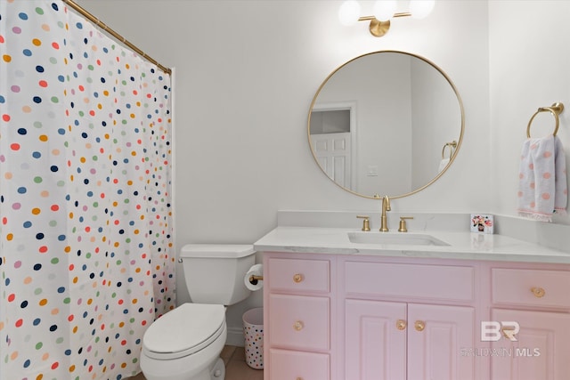 bathroom featuring a shower with shower curtain, vanity, and toilet