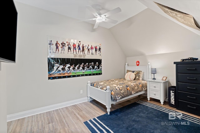 bedroom featuring hardwood / wood-style floors, ceiling fan, and vaulted ceiling