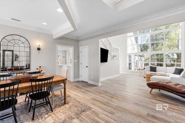 dining area featuring crown molding and light hardwood / wood-style flooring