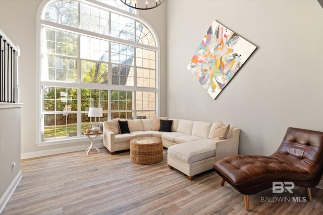 living room featuring light hardwood / wood-style floors and an inviting chandelier