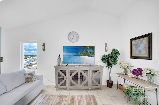 living room featuring light tile patterned floors and vaulted ceiling