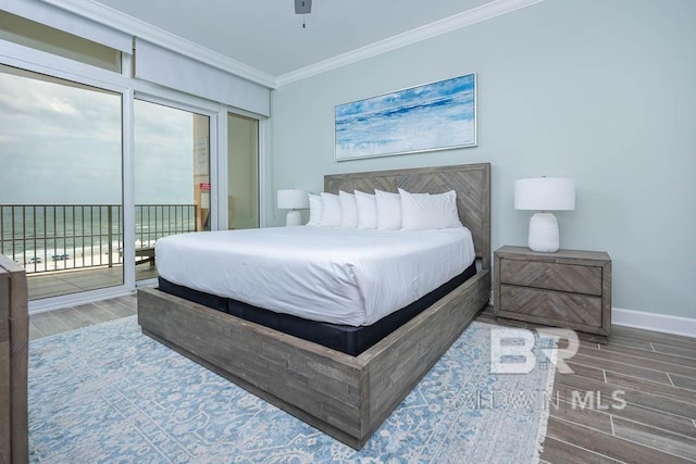 bedroom featuring crown molding, multiple windows, access to exterior, baseboards, and wood tiled floor
