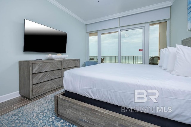 bedroom featuring crown molding, baseboards, wood finished floors, and access to exterior