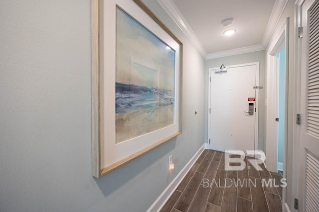 hall with crown molding, baseboards, and wood finish floors