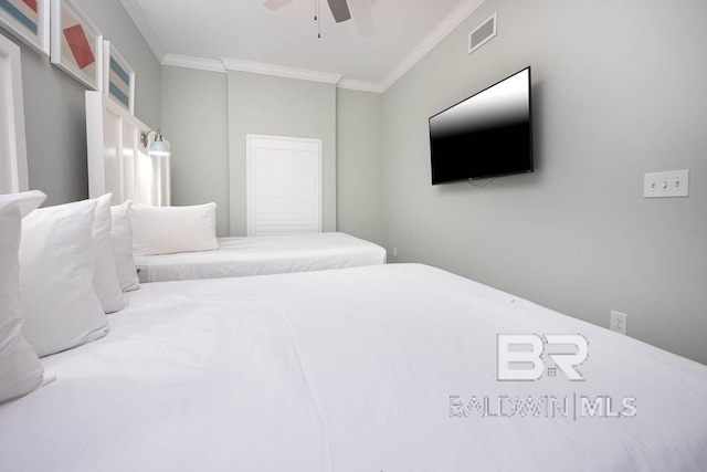 bedroom featuring ornamental molding, a ceiling fan, and visible vents