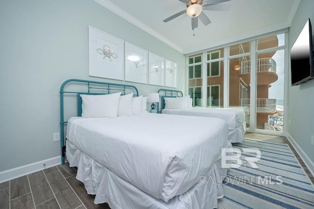 bedroom with crown molding, baseboards, dark wood-style flooring, and ceiling fan