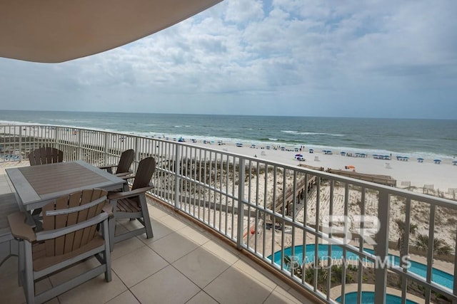 balcony with a water view and a beach view