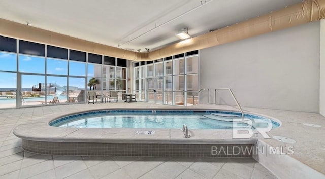pool featuring a patio and an indoor hot tub