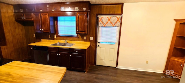 kitchen with sink, dark wood-type flooring, a textured ceiling, and dishwasher