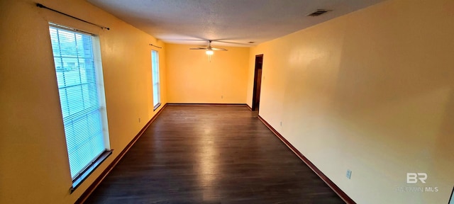 hallway featuring dark wood-type flooring and a textured ceiling