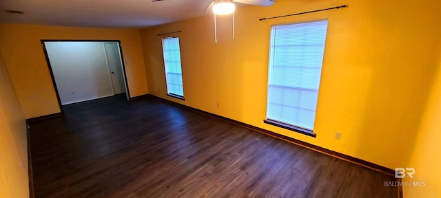 spare room featuring ceiling fan and dark hardwood / wood-style floors