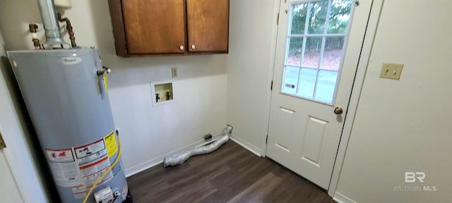 laundry room featuring gas water heater, cabinets, dark hardwood / wood-style floors, and a wealth of natural light